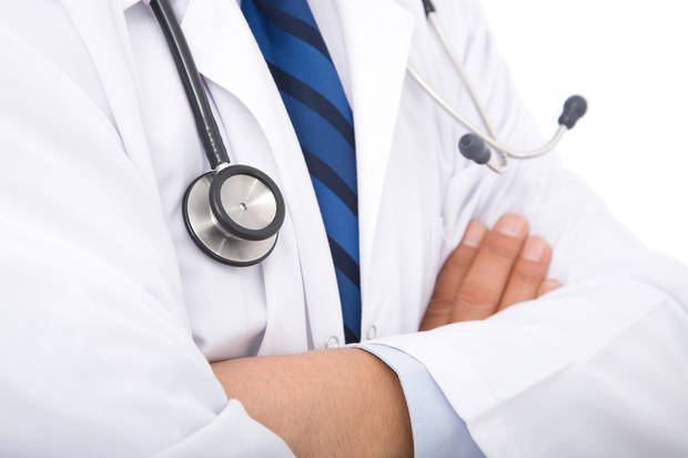 medical doctor with stethoscope on white background