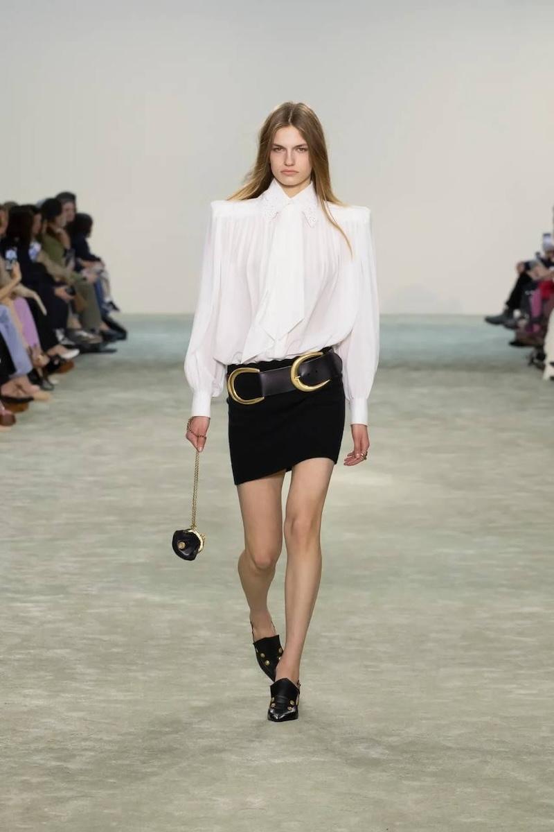 Modelo desfilando para el último desfile de Chloé con minifalda con cinturón.