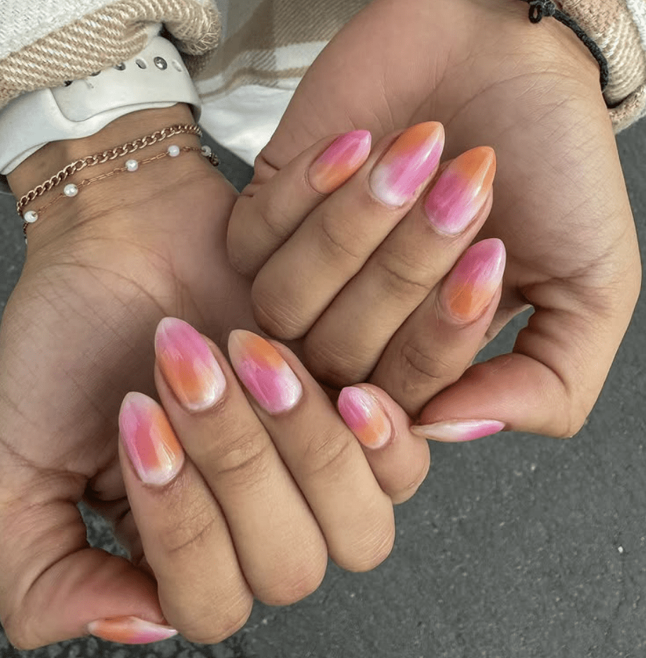 Uñas con diseño shelter en tonos blancos, naranjas y rosas.